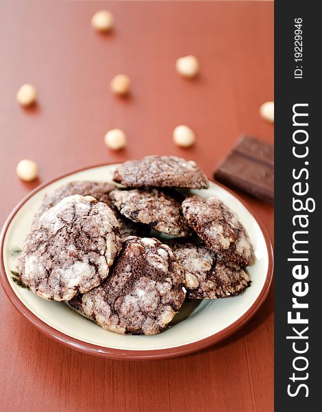 A plate of tasty chocolate cookies with hazlenuts