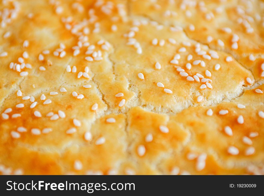 Close up of a crust of bread with sesame seeds