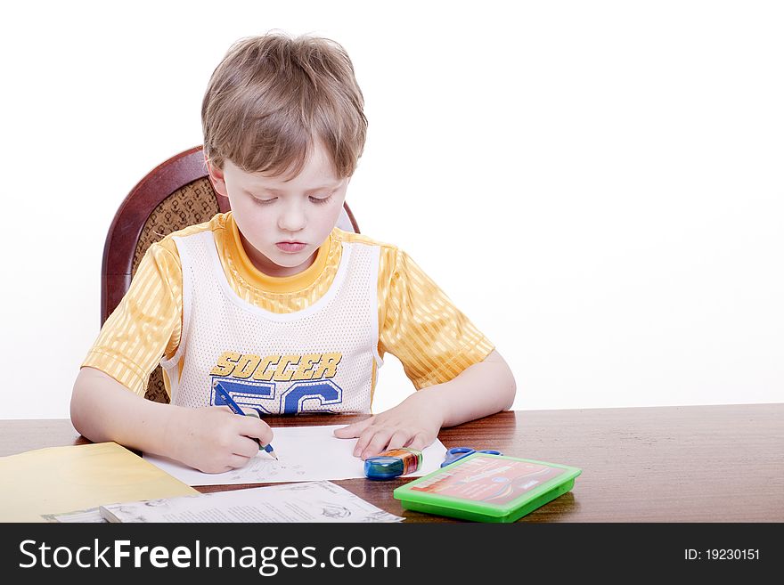 A boy draws with a pencil. A boy draws with a pencil