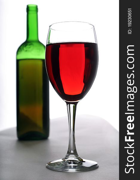 Wineglass and bottle of red wine. Wineglass and bottle of red wine