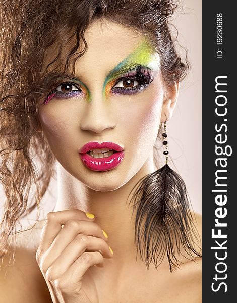 Young attracive female in multicolor make-up