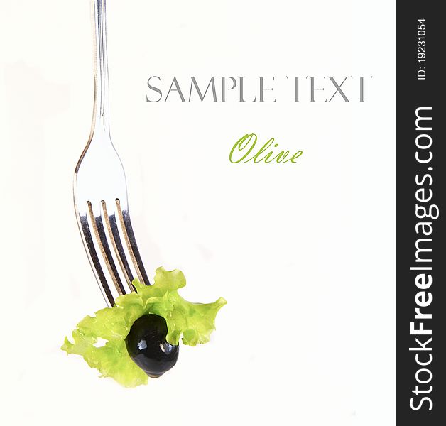 Olive on fork isolated on white background