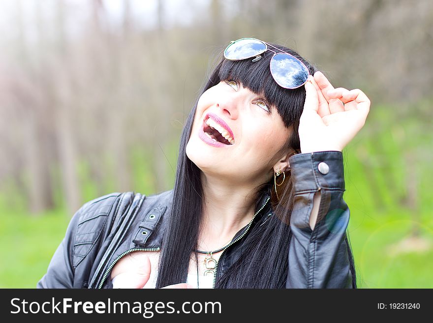 Single young woman wearing sunglasses outdoor. Single young woman wearing sunglasses outdoor