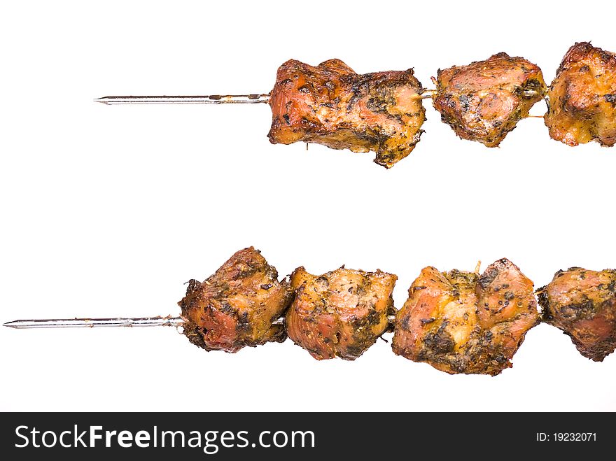 Two skewers of barbecue isolated on white