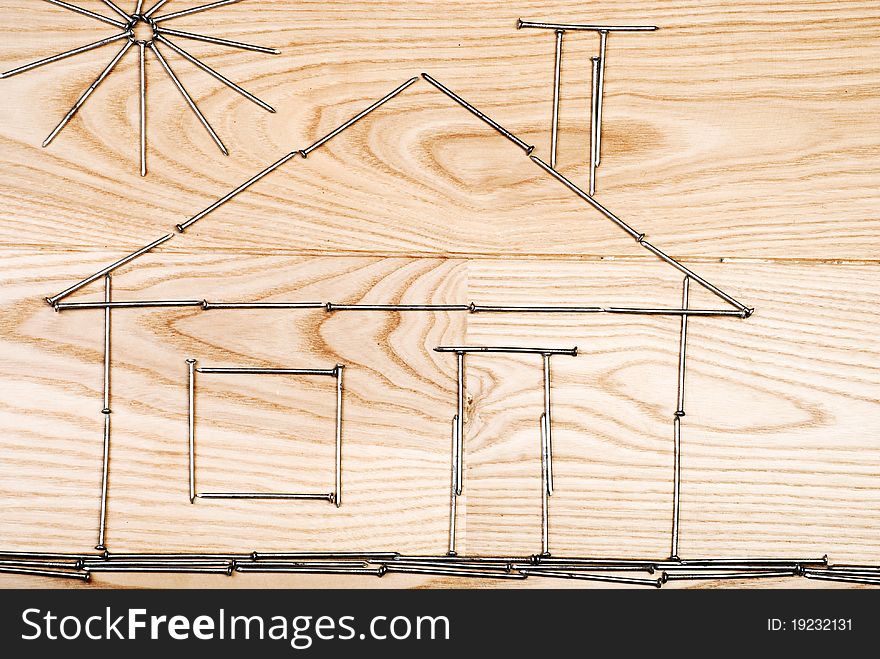 Hause made of nails on wooden background. Hause made of nails on wooden background