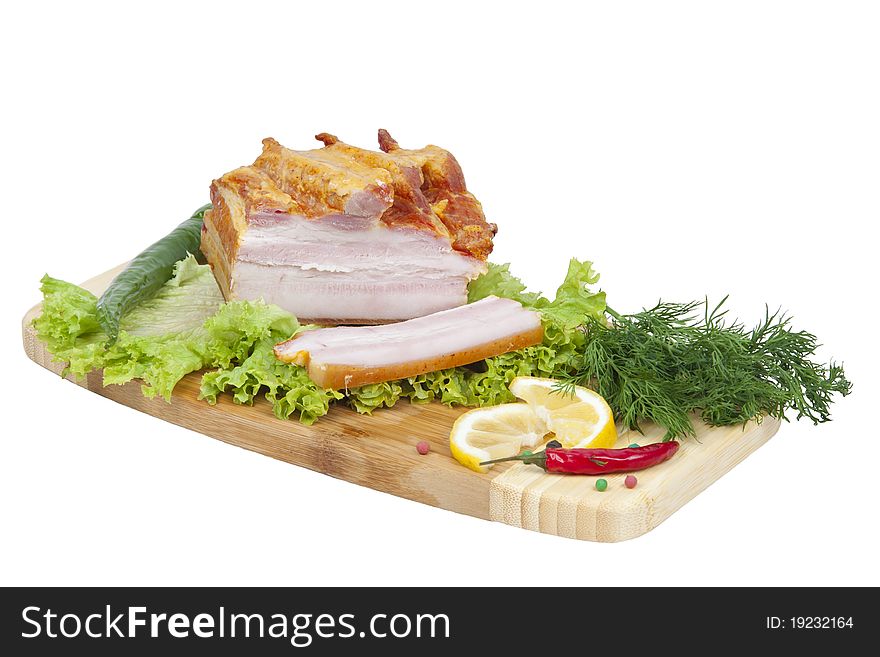 Ham with herbs and spices on a blackboard, isolated on a white background