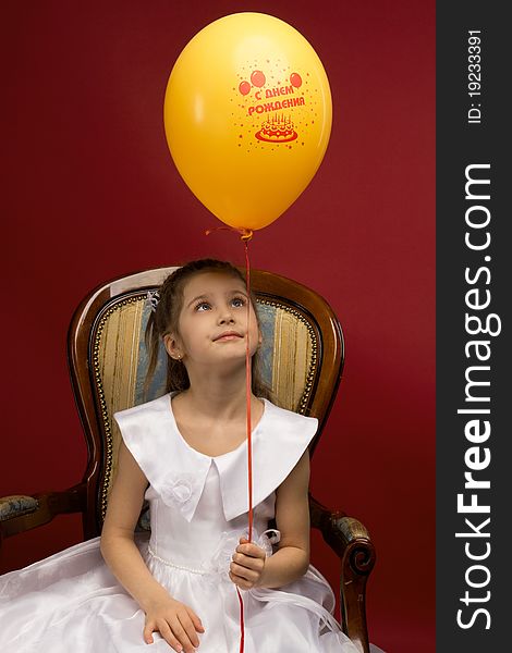 Little girl with yellow balloon