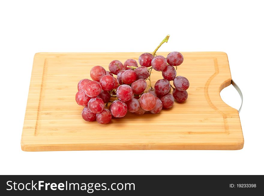 Bunch of grapes on the kitchen blackboard isolated on a white background