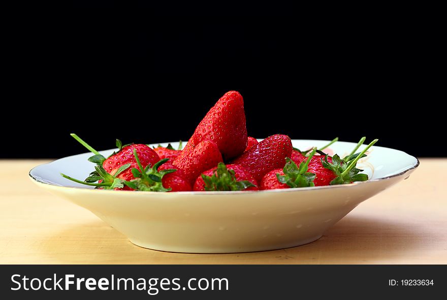 Red strawberry in the plate.