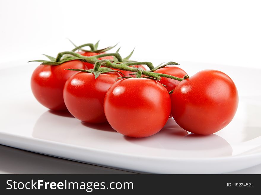 Some tomatos on a plate. Some tomatos on a plate