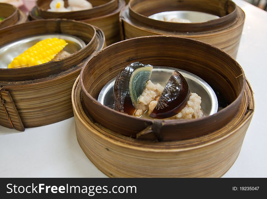 Chinese cuisine Dimsum Preserved egg style in bamboo container closed up. Chinese cuisine Dimsum Preserved egg style in bamboo container closed up