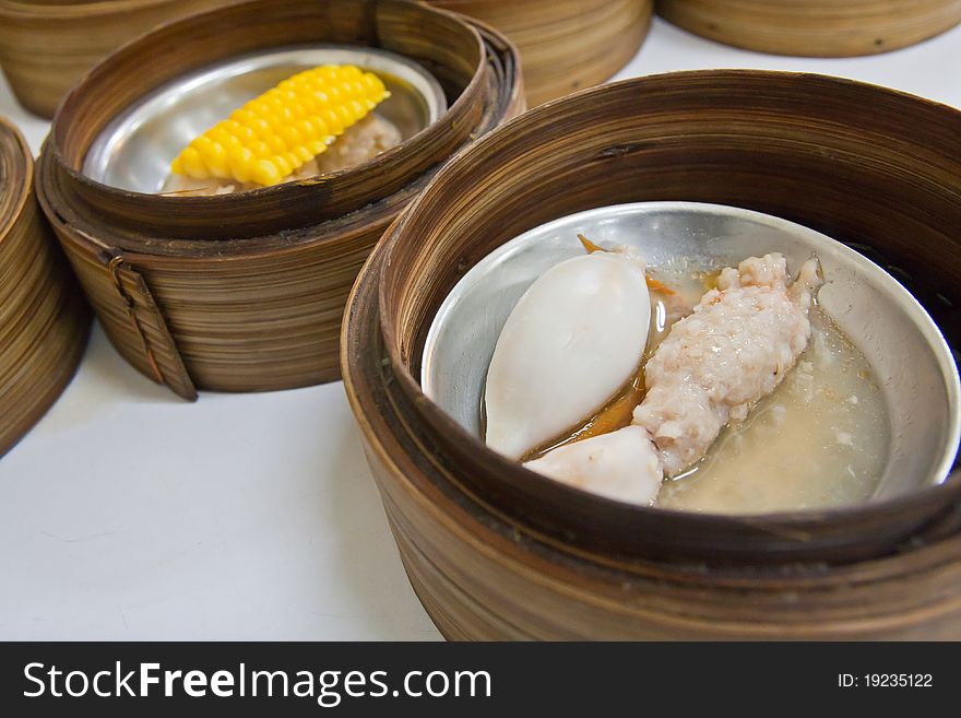 Chinese cuisine Dimsum squid style in bamboo container closed up. Chinese cuisine Dimsum squid style in bamboo container closed up