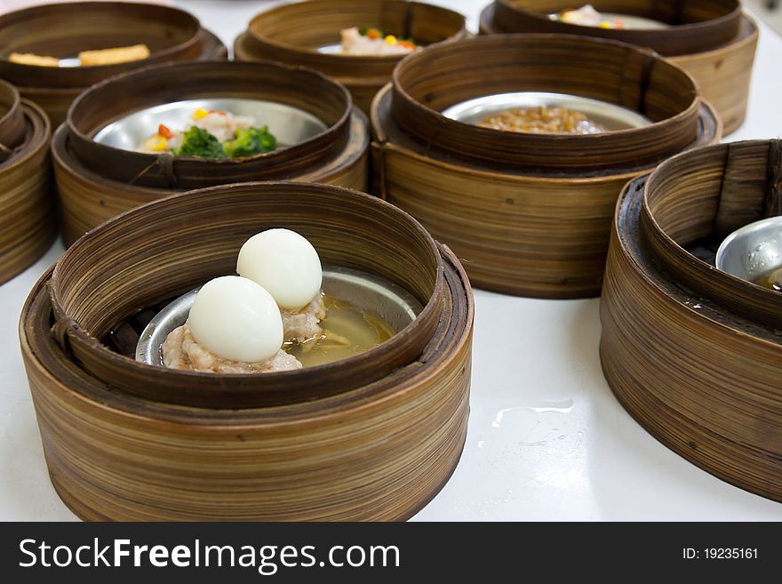 Chinese cuisine Dimsum egg style in bamboo container closed up. Chinese cuisine Dimsum egg style in bamboo container closed up