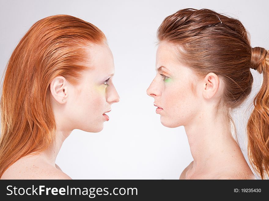 Profile of two red-haired woman