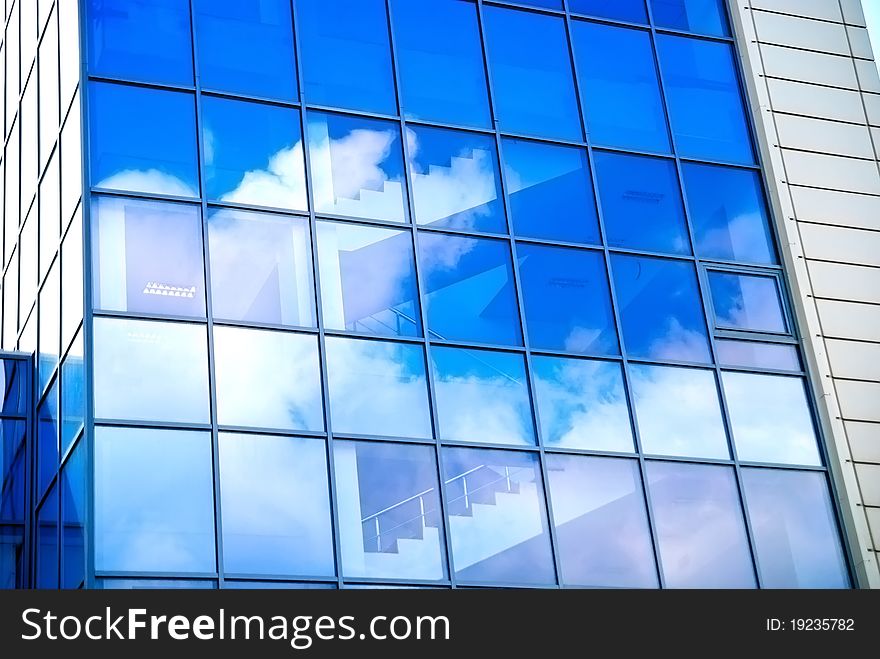 Reflection of the sky and clouds in the windows of a skyscraper. Reflection of the sky and clouds in the windows of a skyscraper