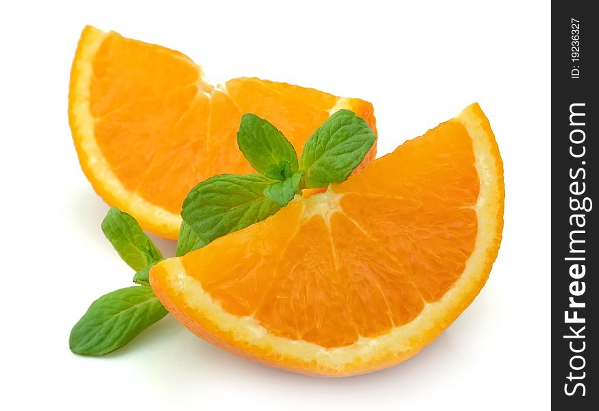 Segments of an orange with mint on a white background