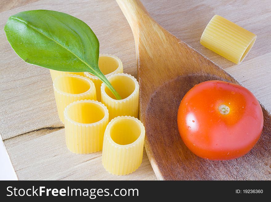 Italian raw pasta with tomato and basil. Italian raw pasta with tomato and basil