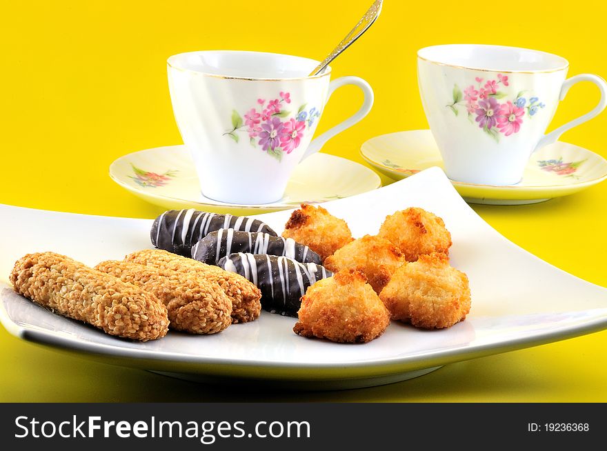 Easter baking on a flat white plate and two cups of tea. Easter baking on a flat white plate and two cups of tea