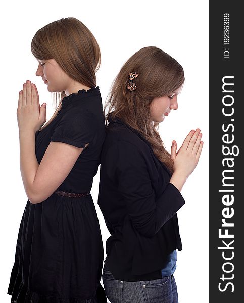 Two girls standing back to back at the time of prayer. Two girls standing back to back at the time of prayer