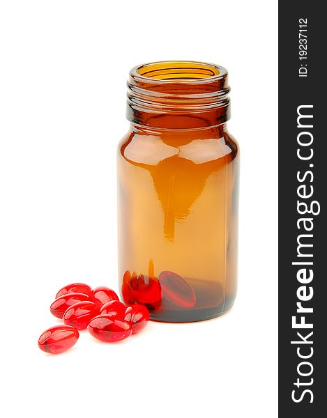 Red vitamin pills in vial isolated on white background. Red vitamin pills in vial isolated on white background