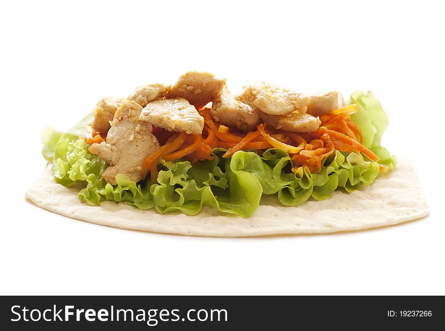 Chicken, lettuce and carrot on tortila isolated on white background. Chicken, lettuce and carrot on tortila isolated on white background