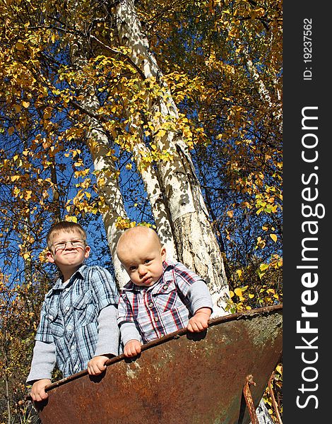Two boys in a wheelbarrow during Autumn in Fairbanks Alaska. Two boys in a wheelbarrow during Autumn in Fairbanks Alaska