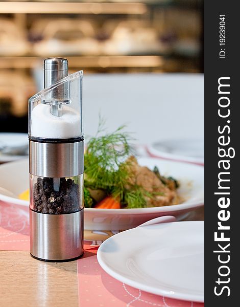 Salt and pepper in metal shaker