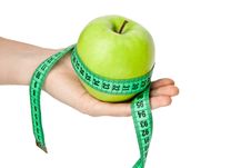 Woman S Hand With Green Apple And Tape Measure Royalty Free Stock Photography