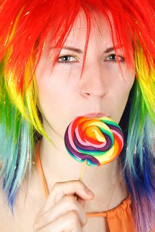 Woman In Multicolored Wig Eating Big Lollipop Royalty Free Stock Images