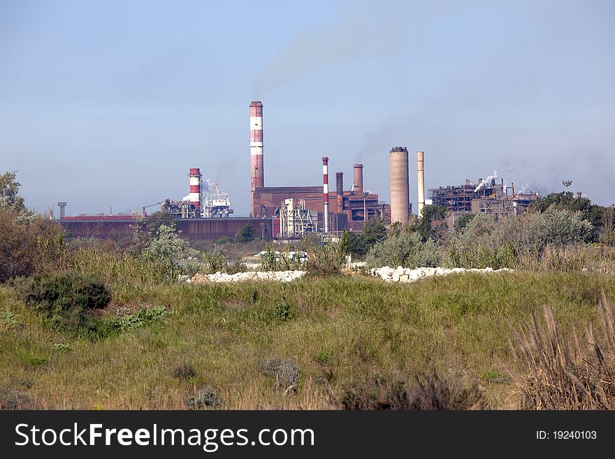 Industrial plant rejecting fumes in atmosphere. Industrial plant rejecting fumes in atmosphere