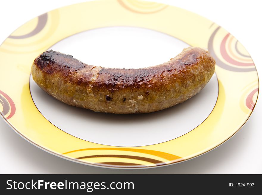 Roasted fried sausage on ceramics plate