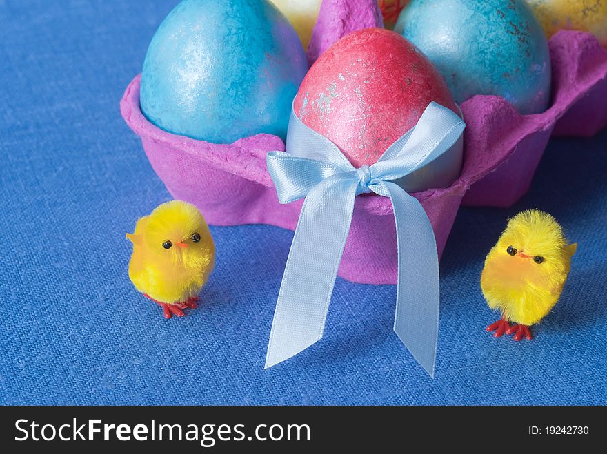 Easter: box with multicolored eggs and funny chicken. Easter: box with multicolored eggs and funny chicken.