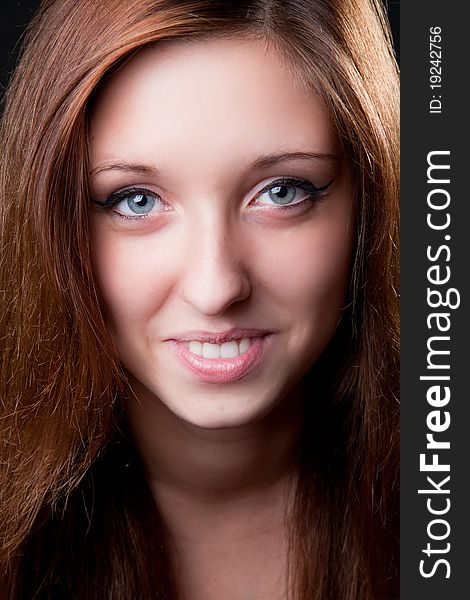 Close-up portrait face of beautiful smiling girl. Studio shot