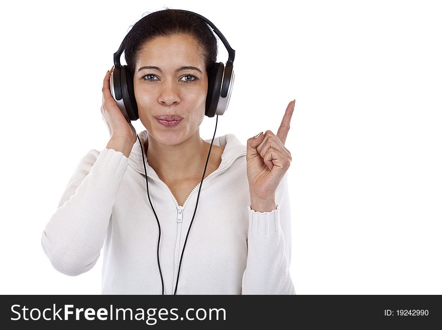 Woman with headphones listening to mp3 music and points with finger. Isolated on white background.