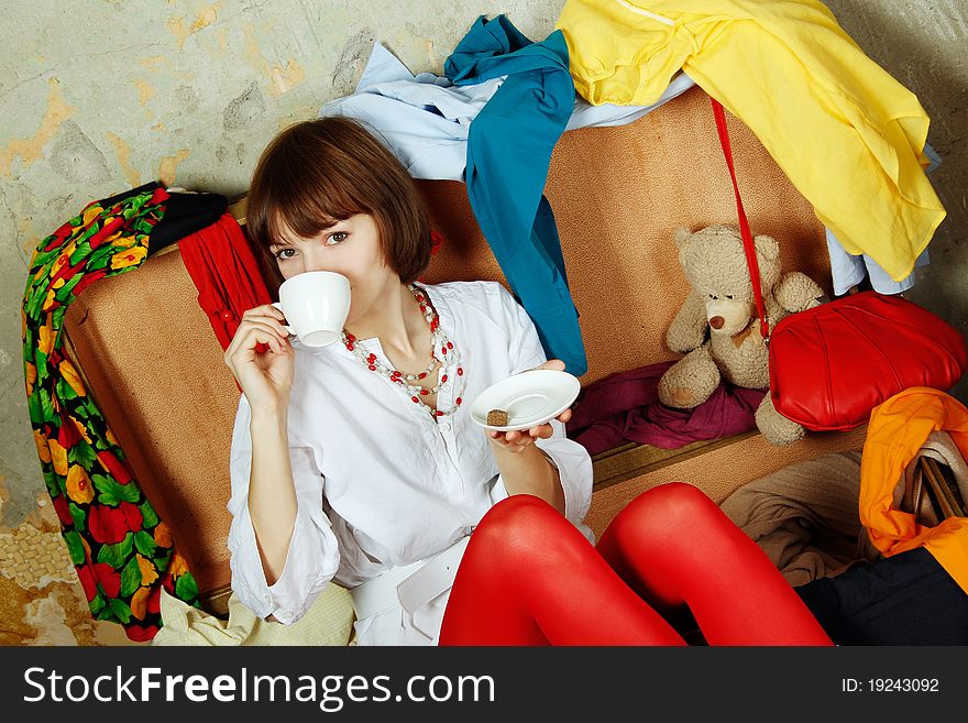 Attractive Woman Sitting In A Suitcase