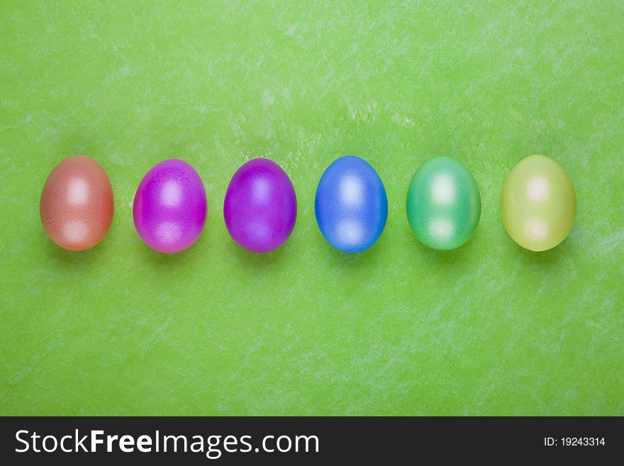 Colorful Easter eggs on a green background