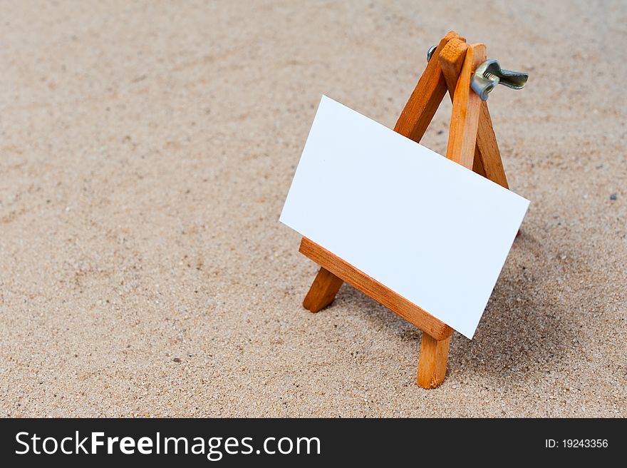 Easel in the sand with blank canvas