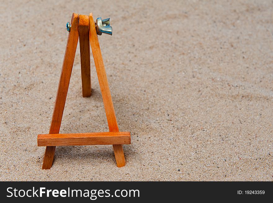 Empty easel in the sand