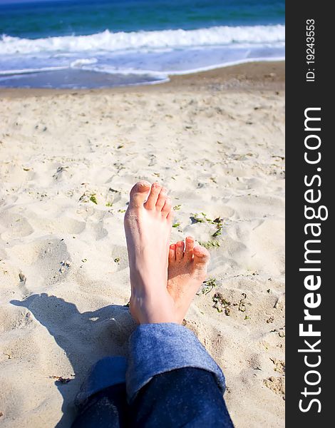 Girl's feet on the background of the sea. Girl's feet on the background of the sea