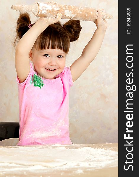 Happy young girl kneading dough. Happy young girl kneading dough