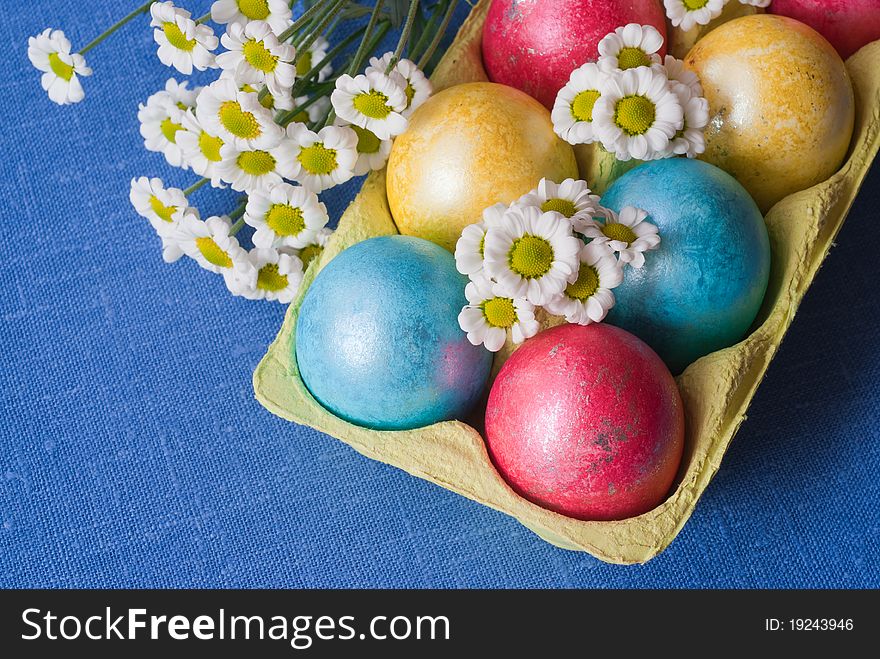 Easter eggs in box is decorated with flowers. Easter eggs in box is decorated with flowers.