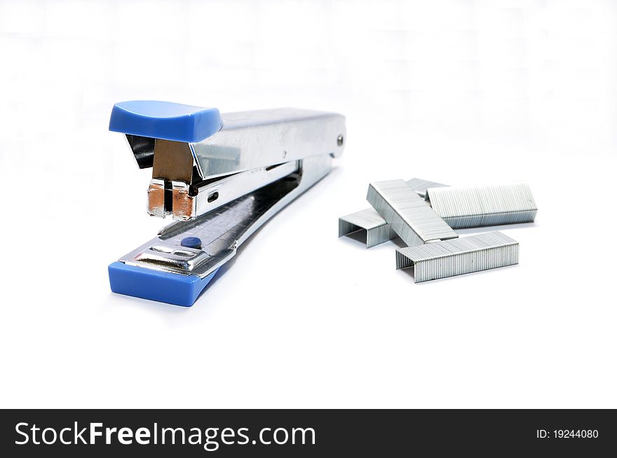 Isolated blue stapler and staples on white
