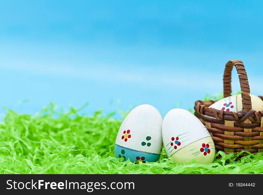 Three easter eggs in a small basket