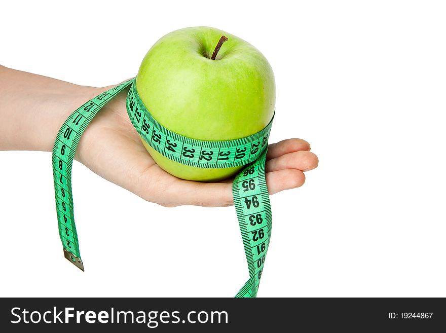 Woman's hand with green apple and tape measure isolated on white