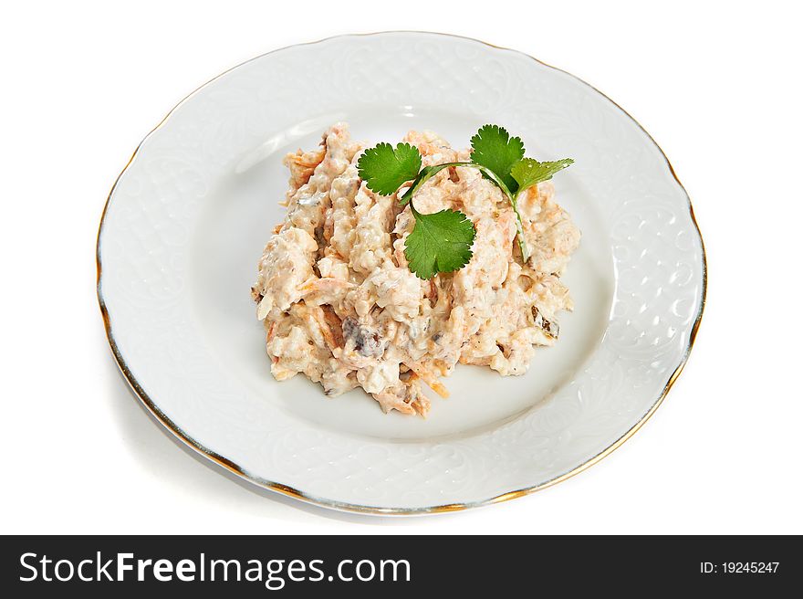 Salad with tuna and eggs, carrots, onions isolated on plate on white background