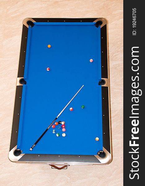 A blue billiard table top view with marble floor background