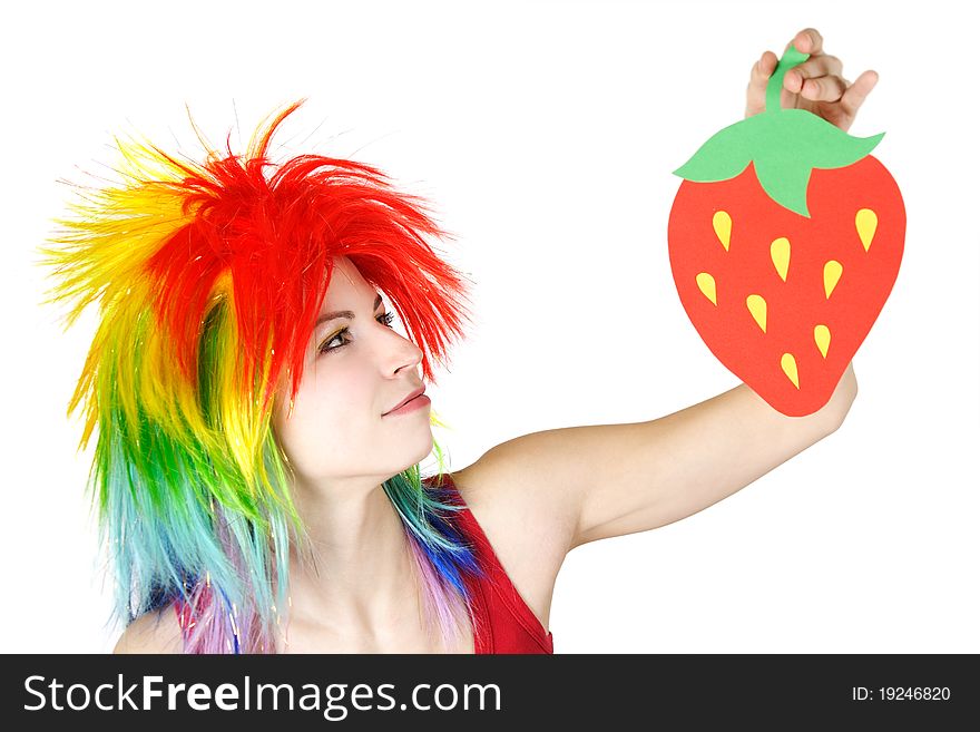 Young beauty woman in multicolored clown wig holding strawberry cardboard, isolated. Young beauty woman in multicolored clown wig holding strawberry cardboard, isolated