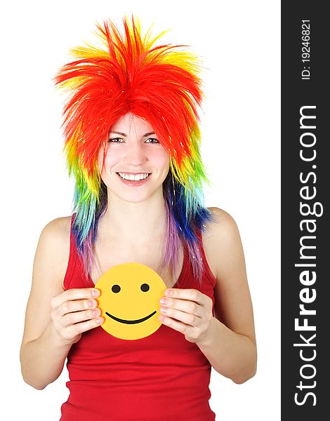 Young beauty woman in multicolored clown wig smiling and holding cardboard smile, isolated. Young beauty woman in multicolored clown wig smiling and holding cardboard smile, isolated