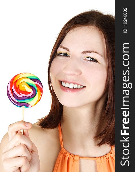 Young brunette girl holding big multicolored lollipop and smiling, isolated. Young brunette girl holding big multicolored lollipop and smiling, isolated