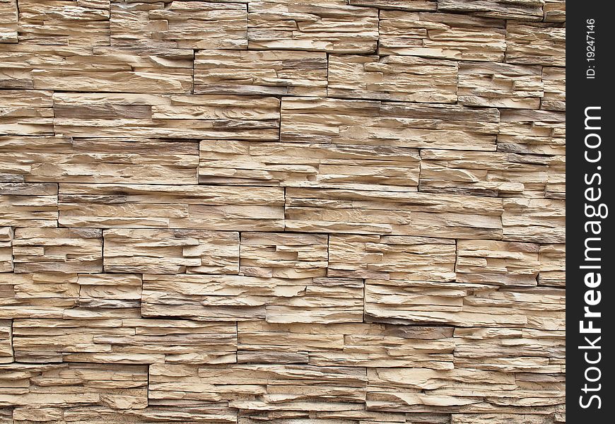 A wall covered with light stone ribbed texture. A wall covered with light stone ribbed texture.
